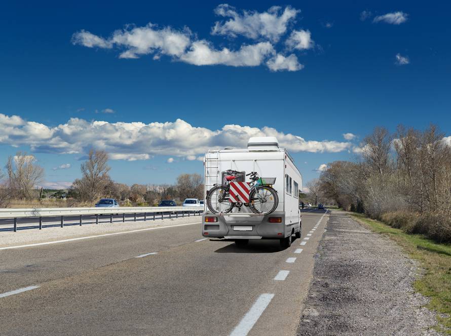 RV traveling to campground on 4-lane highway