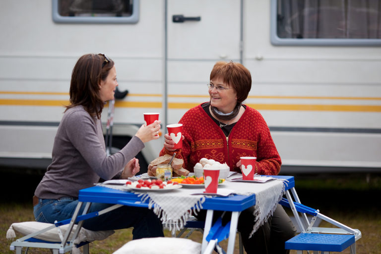2 women at an rv campground picic table