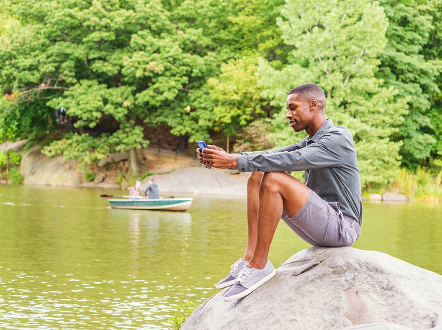 man waiting learning about houseboat rentals on tablet
