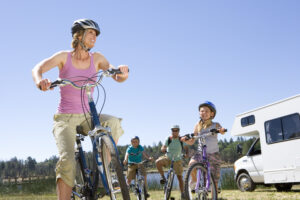 Family riding bikes while RV Camping